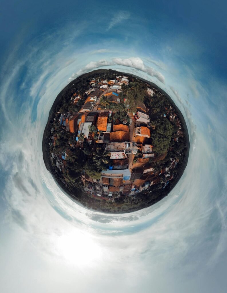 Stunning spherical aerial shot capturing the vibrant landscape of a rural village under a clear blue sky.
